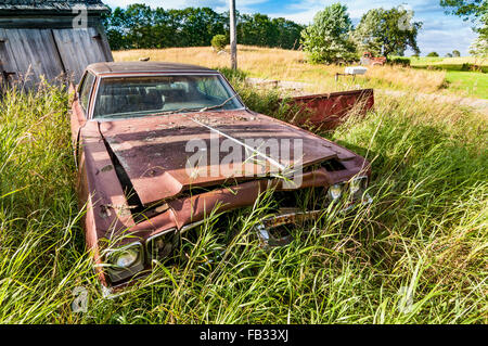 old wrecking car in countryside in Maine, Usa Stock Photo