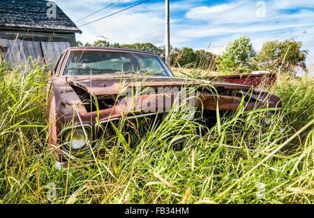 old wrecking car in countryside in Maine, Usa Stock Photo