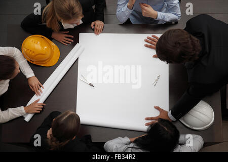 Top view of people around table in construction business meeting Stock Photo