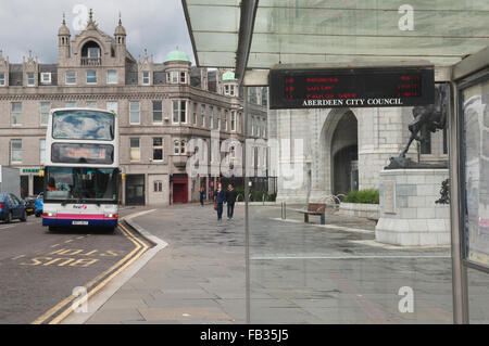 Bus approaching bus stop in Aberdeen city centre, outside Marischal College - Scotland, UK. Stock Photo