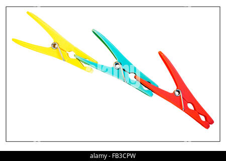 Three coloured pegs clipped together against a white background Stock Photo