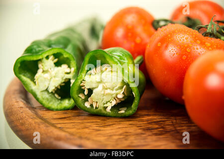 Tomatoes and peppers on a wooden surface Stock Photo
