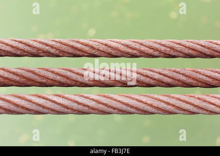 background of three rusty wire rope sling Stock Photo