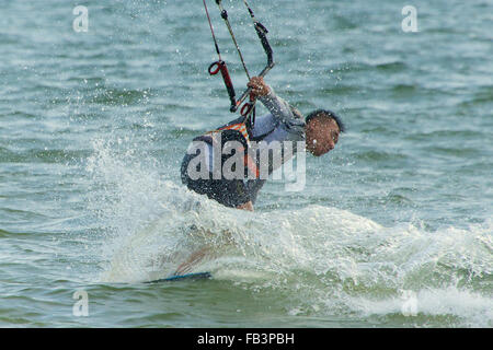 Male kite surfer losing grip on bar Stock Photo