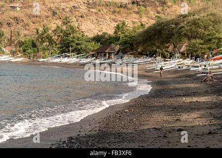 traditional outrigger fishing boats on the black beach in Jemeluk, Amed, Bali, Indonesia Stock Photo