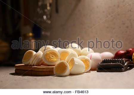 Freshly boiled eggs lying in yellow warm light Stock Photo