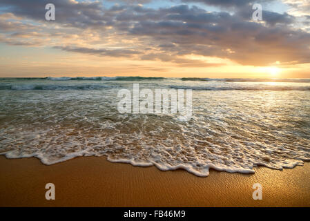 Bright cloudy sunset in the calm ocean Stock Photo