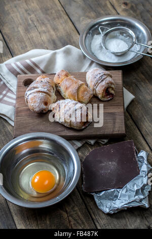 Baked croissants stuffed with sweet fruit jam Stock Photo