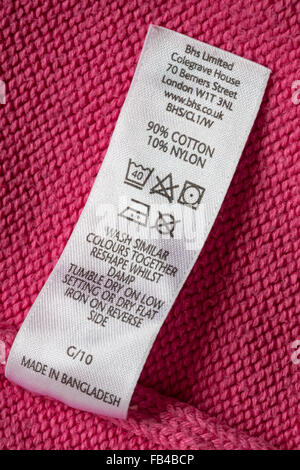 care label in pink jumper made up of 70% angora and 30% nylon Stock ...