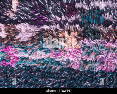 Close up of detail from a colourful home made deep floss rug with irregular abstract pattern Stock Photo