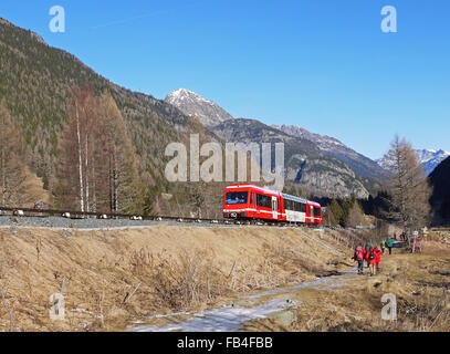 The Mont blanc Express train near Le Buet Haute Savoie France with walkers following a trail from Le Buet to Vallorcine Stock Photo