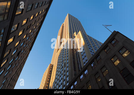 Empire State Building at sunset from below. Low angle view of the Art Deco skyscraper located in Midtown Manhattan, New York.
