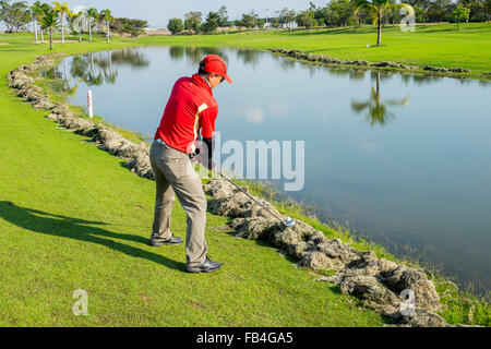 Ayuthaya, Thailand - December 27, 2015 : Golfer trying to play the ball on cut grass Stock Photo