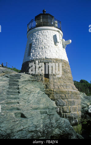 Steps are carved out on rock ledge by Castle Hill lighthouse as the beacon itself is a unique stone structure in Newport, Rhode Island. Stock Photo