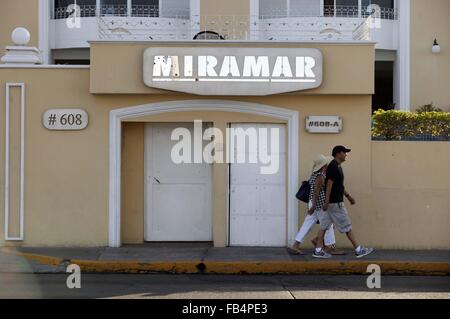 (160109) -- MAZATLAN, Jan 9, 2016 (Xinhua) -- File photo taken on July 12, 2015 shows people walking past the Miramar condominium, the site where Mexico's drug cartel kingpin Joaquin Guzman Loera was arrested during his previous escape from prison on Feb. 22, 2014, in the city of Mazatlan, Sinaloa, Mexico. After an early morning raid in northwestern Mexico's Sinaloa State's town of Los Mochis by Mexican police and marines on Friday, Sinaloa Cartel leader Joaquin 'El Chapo' Guzman Loera was recaptured, six months after his second prison break. In 2001, Guzman was wheeled out by a janitor in a l Stock Photo