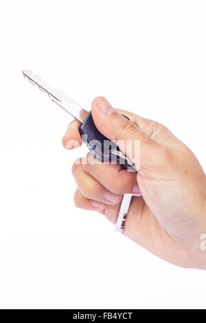 Hand with a car key isolated on white background, stock photo Stock Photo