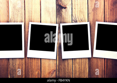 Instant blank polaroid photo frames on wooden background. Free copyspace. Vintage retro. Stock Photo