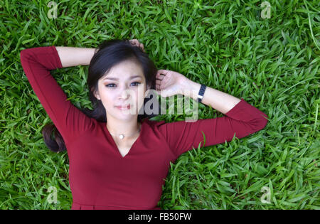 pretty woman in red dress at the garden Stock Photo