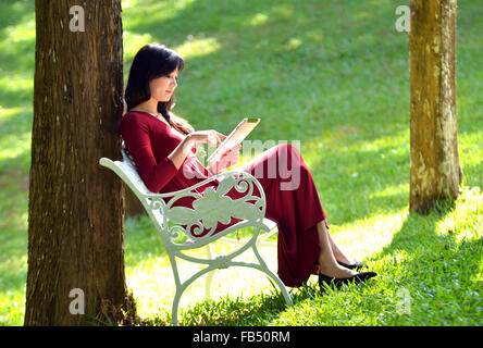 pretty  woman using  tablet in the garden Stock Photo