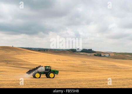 John Deere self propelled sprayer spraying herbicide on a field in advance of preparing it to plant in the Palouse region of Eas Stock Photo