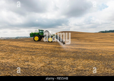 John Deere self propelled sprayer spraying herbicide on a field in advance of preparing it to plant in the Palouse region of Eas Stock Photo