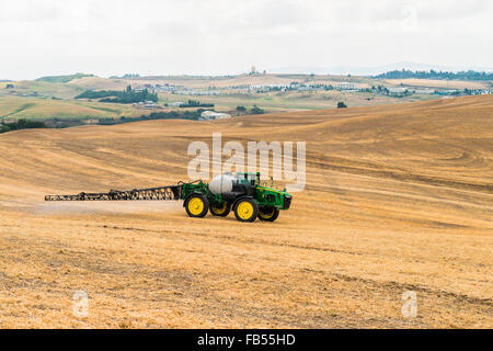 John Deere self propelled sprayer spraying herbicide on a field in advance of preparing it to plant in the Palouse region of Eas Stock Photo