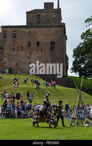 A Medieval knight on horseback and squire at a jousting tournament at Linlithgow Palace, Scotland Stock Photo