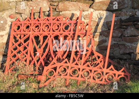 Stack of old Iron railings sat on the grass Stock Photo