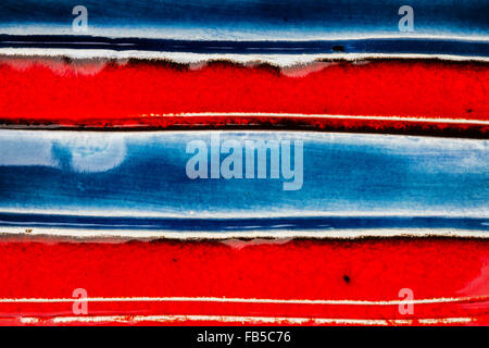 Closeup shot of glazed red and blue ceramics texture Stock Photo