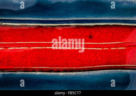 Closeup shot of glazed red and blue ceramics texture Stock Photo