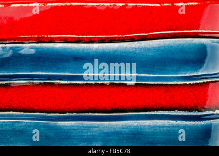 Closeup shot of glazed red and blue ceramics texture Stock Photo