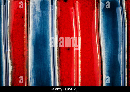 Closeup shot of glazed red and blue ceramics texture Stock Photo