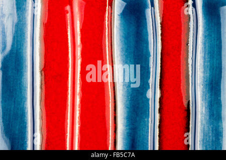 Closeup shot of glazed red and blue ceramics texture Stock Photo