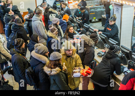 Hungry and eager customers crowd the counter at a McDonald's restaurant in Times Square in New York on Tuesday, January 5, 2016. McDonald's third quarter sales grew 0.9 percent, their first increase in two years. McDonald's, Wendy's and Burger King have all launched limited value meal options and McD's all day breakfast helped boost its last quarter. (© Richard B. Levine) Stock Photo