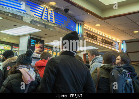 Hungry and eager customers crowd the counter at a McDonald's restaurant in Times Square in New York on Tuesday, January 5, 2016. McDonald's third quarter sales grew 0.9 percent, their first increase in two years. McDonald's, Wendy's and Burger King have all launched limited value meal options and McD's all day breakfast helped boost its last quarter. (© Richard B. Levine) Stock Photo