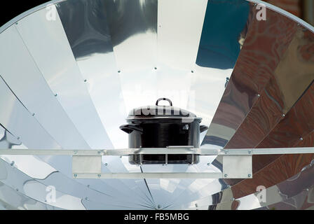 Black pot on a Solar cooker Stock Photo