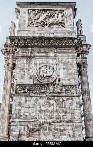 The Arch of Constantine is a triumphal arch in Rome, situated between the Colosseum and the Palatine Hill. Stock Photo