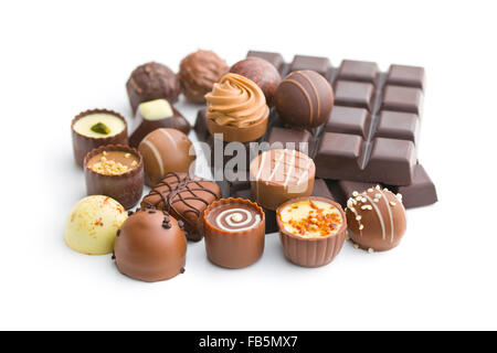 various chocolate pralines and chocolate bar on white background Stock Photo