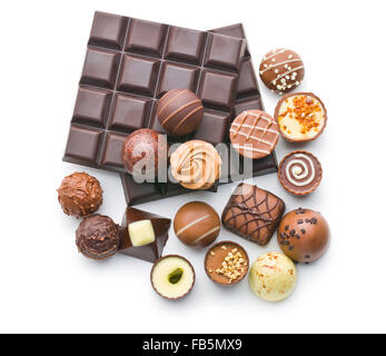 various chocolate pralines and chocolate bar on white background Stock Photo