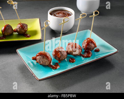 Beef meatballs with barbecue tomato sauce and parmesan cheese in cast ...