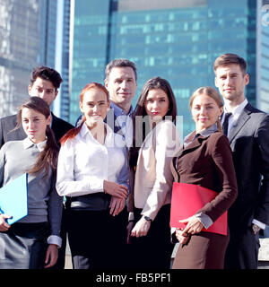 Portrait of business team outside office on skyscrapers background Stock Photo
