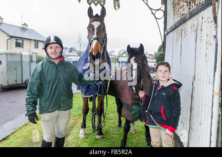 Drimoleague, Ireland. 10th January, 2016. Tim O'Leary and son, Michael from Skibbereen give their noble steeds 'Hunter' and 'Chocco' a well earned rest after the Drimoleague to Drinagh Cheval. The Cheval was held to raise funds for COPE Foundation. Credit: Andy Gibson/Alamy Live News Stock Photo