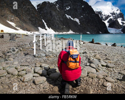 South Orkney Islands, Laurie Island, Orcadas base cemetery, tourist photographing crosses marking graves Stock Photo