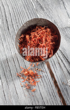 saffron in old spoon on wooden background Stock Photo