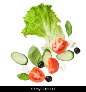 flying salad isolated in white - red tomatoes, pepper, cheese, basil, cucumber and olives Stock Photo