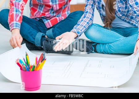 Pleasant couple drawing plan Stock Photo