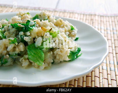 Babenda - flavor of funky rice, dried or smoked fish, and bitter greens.Burkina Faso. Stock Photo