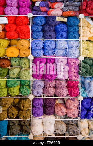 skeins of yarn stacked on shelves Stock Photo