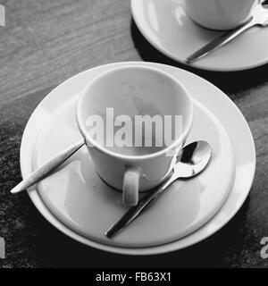 Time to reflect over a empty coffee cup in black and white Stock Photo