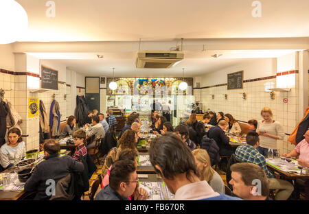 Brussels Restaurant Le Pré Salé interior with people eating mussels fries chips moules frites and other traditional Belgian food Stock Photo